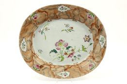 quite rare oval 18th Cent. Chinese "faux marbre" dish in porcelain with a 'Famille Rose' flower deco
