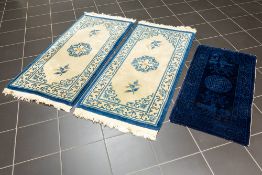 three small Chinese rugs, amongst which one 'antique' from Bejing