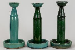 three antique Chinese candlesticks in blueish/green glazed earthenware