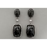 pair of earrings in white gold (18 carat) with two cabochon cut "cat's eyes" , two small high qualit
