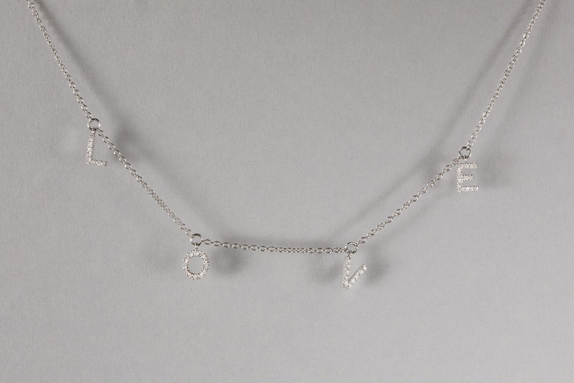 Rino signed necklace in white gold (18 carat) with four pendants that spell 'Love' with ca 0,24 cara