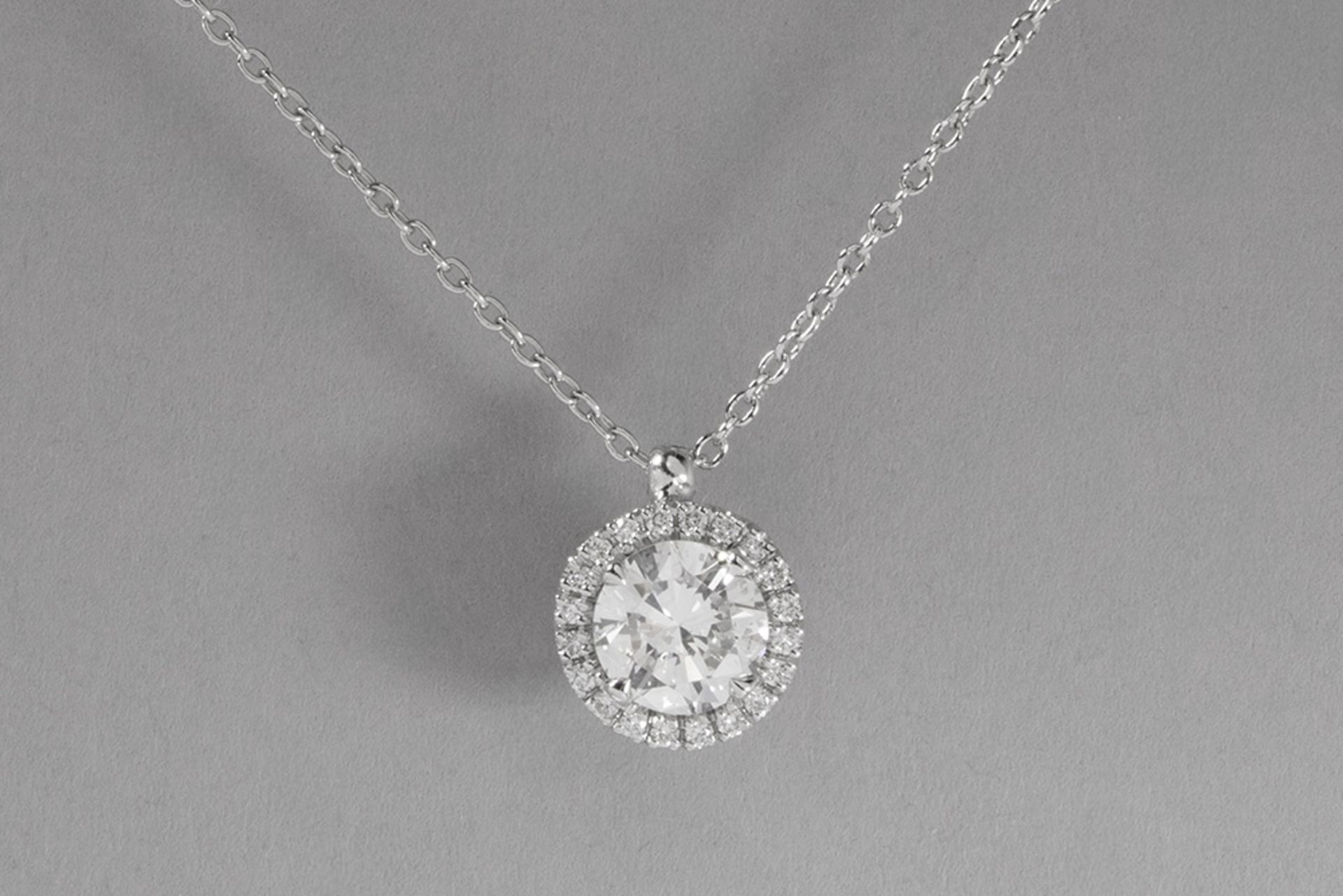 pendant in white gold (18 carat) with a central 1 carat high quality brilliant cut diamond surrounde