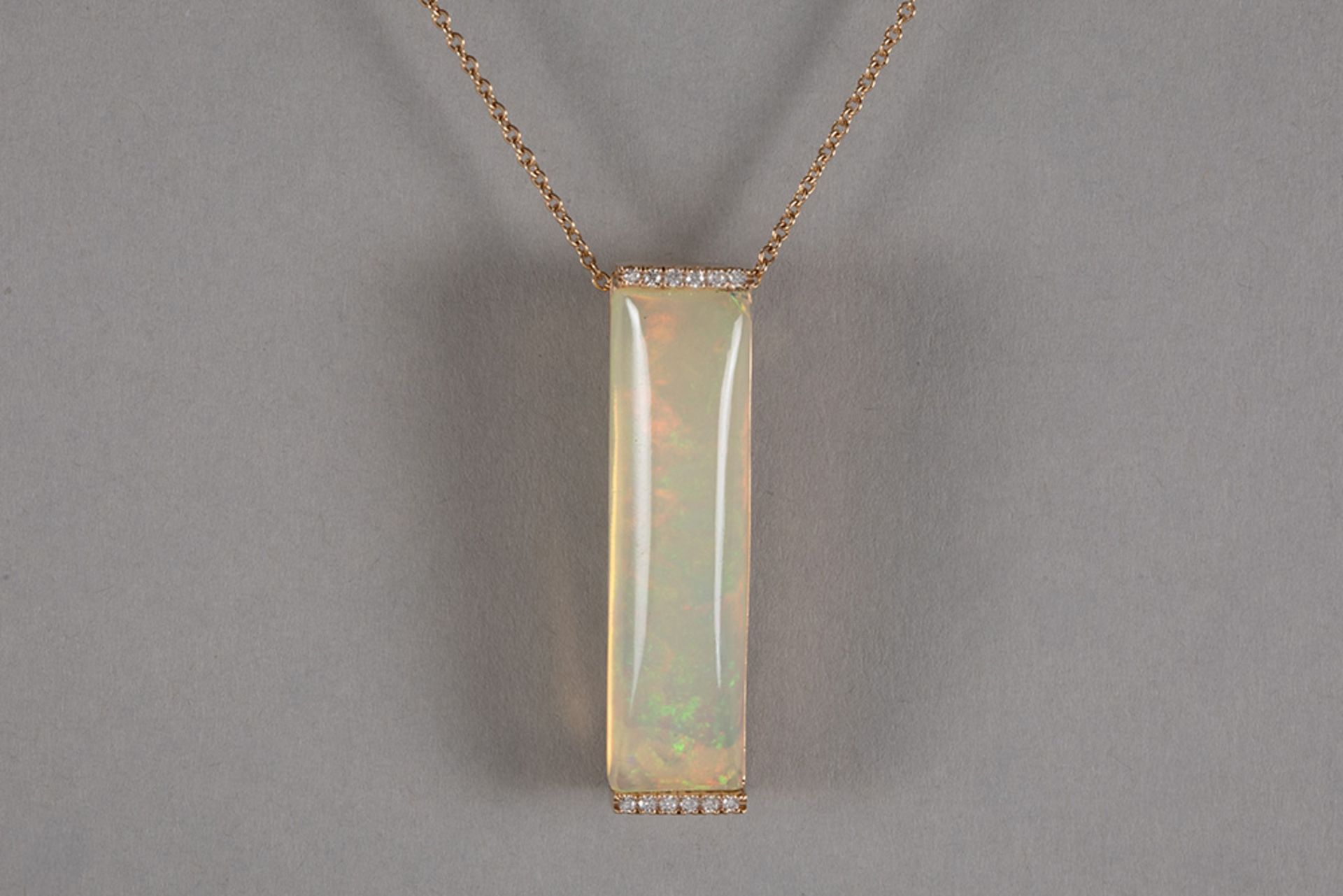 quite special pendant in pink gold (18 carat) with a 12,56 carat opal with a special cabochon shape 