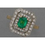 Art Deco style ring in grey gold (18 carat) with a ca 1 carat Colombian emerald surrounded by ca 0,7