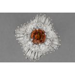 classy cocktail ring in platinum with a ca 1,30 carat orange sapphire surrounded by ca 3 carat of ve