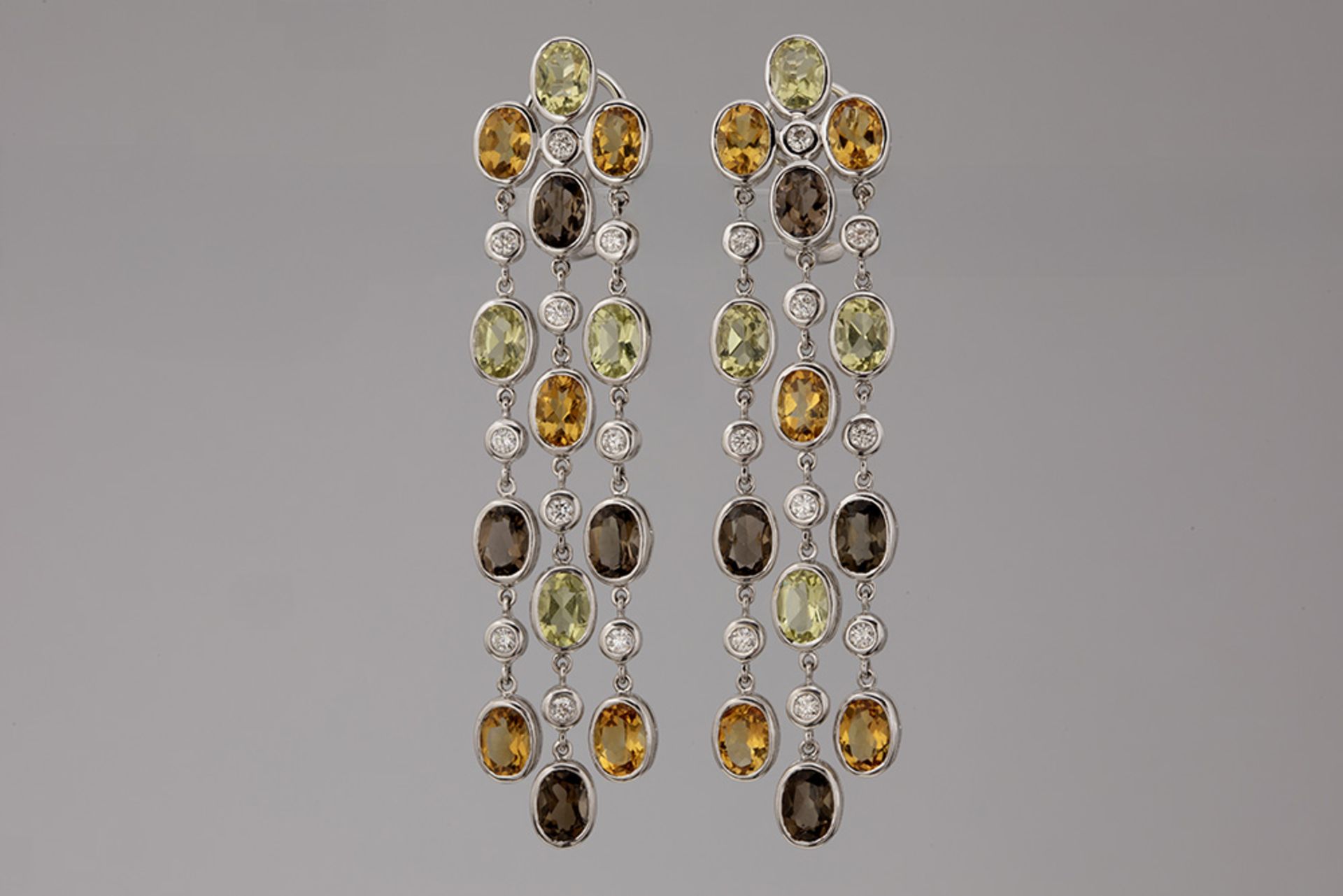 pair of quite long earrings in white gold (18 carat) with semi-precious gems (citrine, topaz and smo