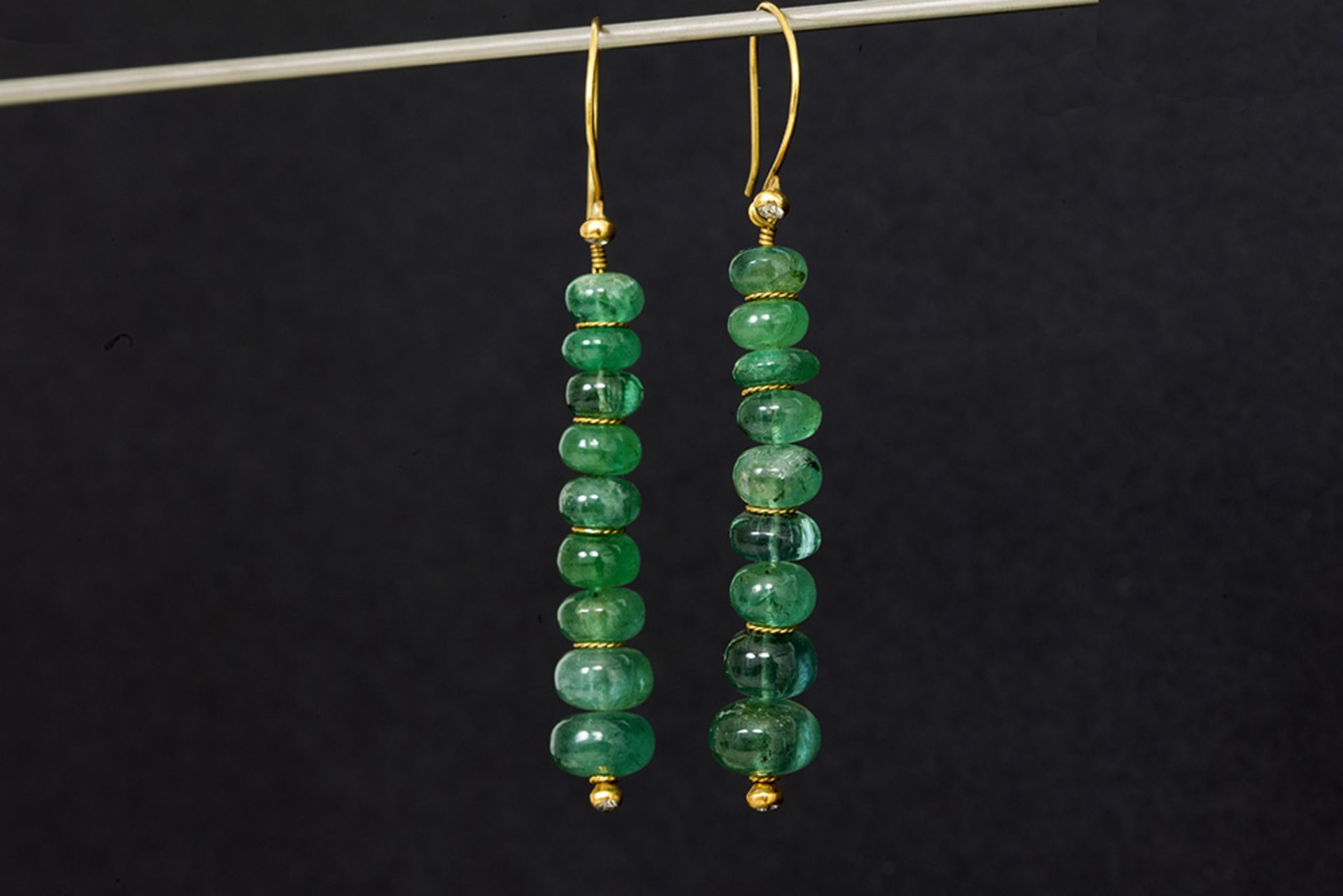 pair of earrings in yellow gold (22 carat) with ca 23 carat of emeralds and each with a small brilli