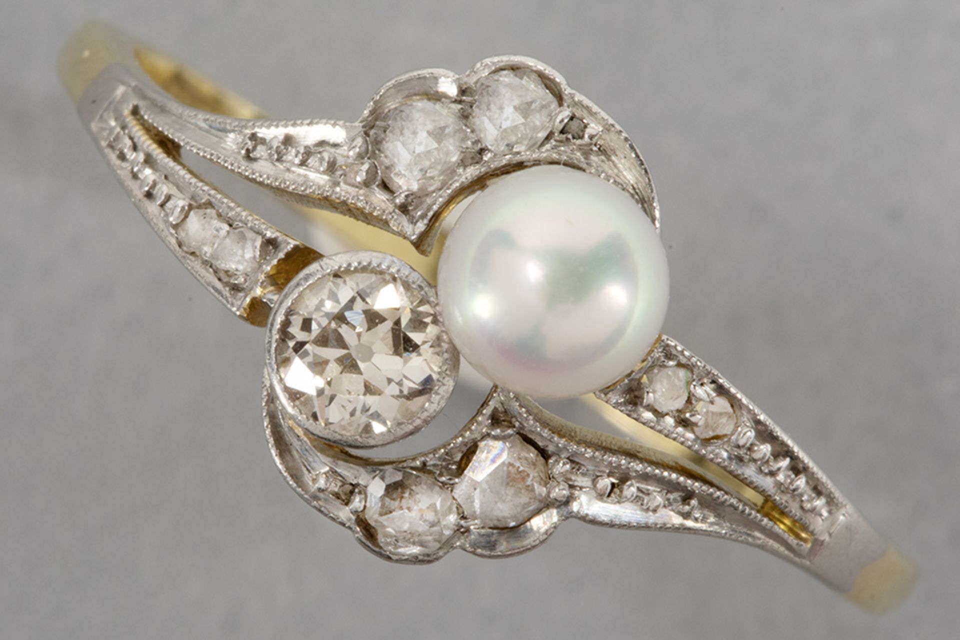 antique ring in grey and yellow gold (18 carat) with a pearl and diamond