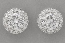 pair of earrings in white gold (18 carat) with two bigger very high quality brilliant cut diamonds (
