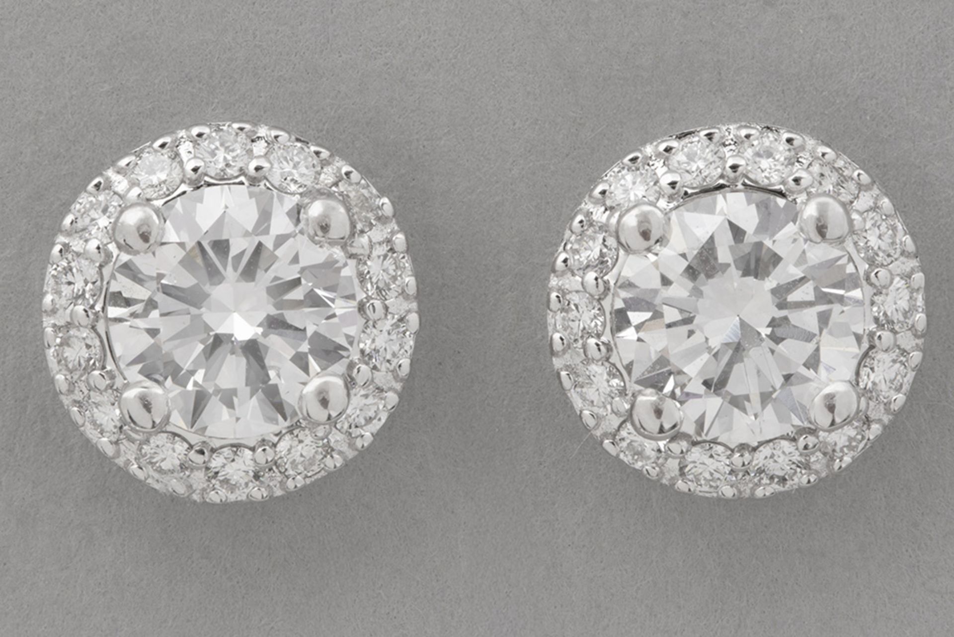 pair of earrings in white gold (18 carat) with two bigger very high quality brilliant cut diamonds (