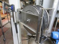 Un-named wall mounted retractable hose with lance