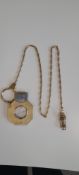 9 carat gold cigar cutter, engine turned decoration with unmarked 9 carat chain, 9 carat gold