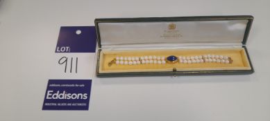 1 medium green box – a pearl bracelet with a navy-blue stone in the centre