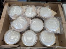 Box of 100 gold edged tea saucers.