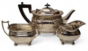 A George VI silver three piece boat shaped tea service, comprising teapot, milk jug and sugar