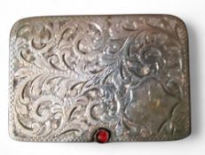 An Edwardian silver rounded rectangular double stamp case, the sliding cover engraved and chased