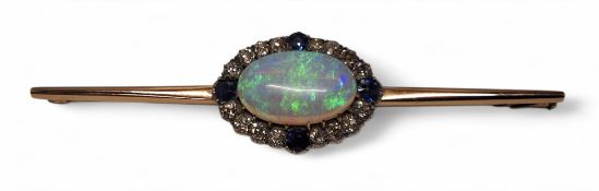 A rose gold coloured metal bar brooch, the central setting set with a oval black opal 12 x 19mm,