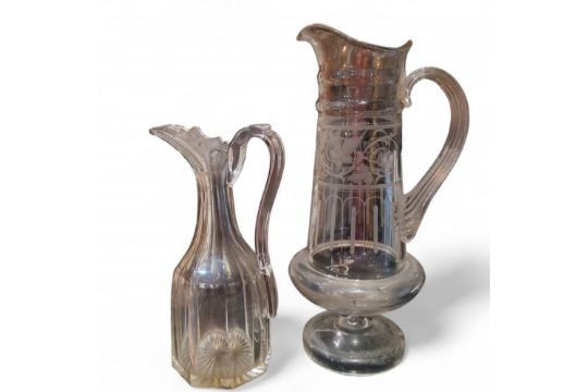 A late 19th century tall cut glass water jug, etched with scrolling vine, above arches, ribbed