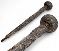 A 19th century Chinese white metal parasol handle,  decorated in relief with ferocious dragons