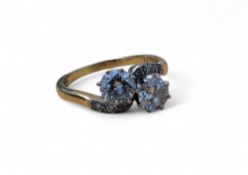 An 18ct gold diamond crossover/twist ring set with two round diamonds, colour G/H, VS2 approx.