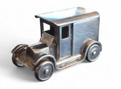 An apprentice-piece white metal model loosely based on a Ford Model A panel van, rotating wheels,