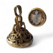 A 9ct gold seal fob, set with faceted champagne coloured stone, etched in relief with a shield
