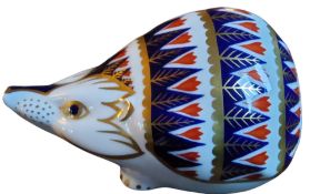 A  Royal Crown Derby paperweight, of a Hedgehog, gold stopper
