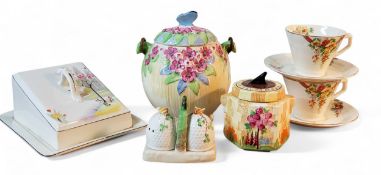 A Burleigh Ware biscuit barrel, in relief with stylised flowers, butterfly finial, 19cm high,