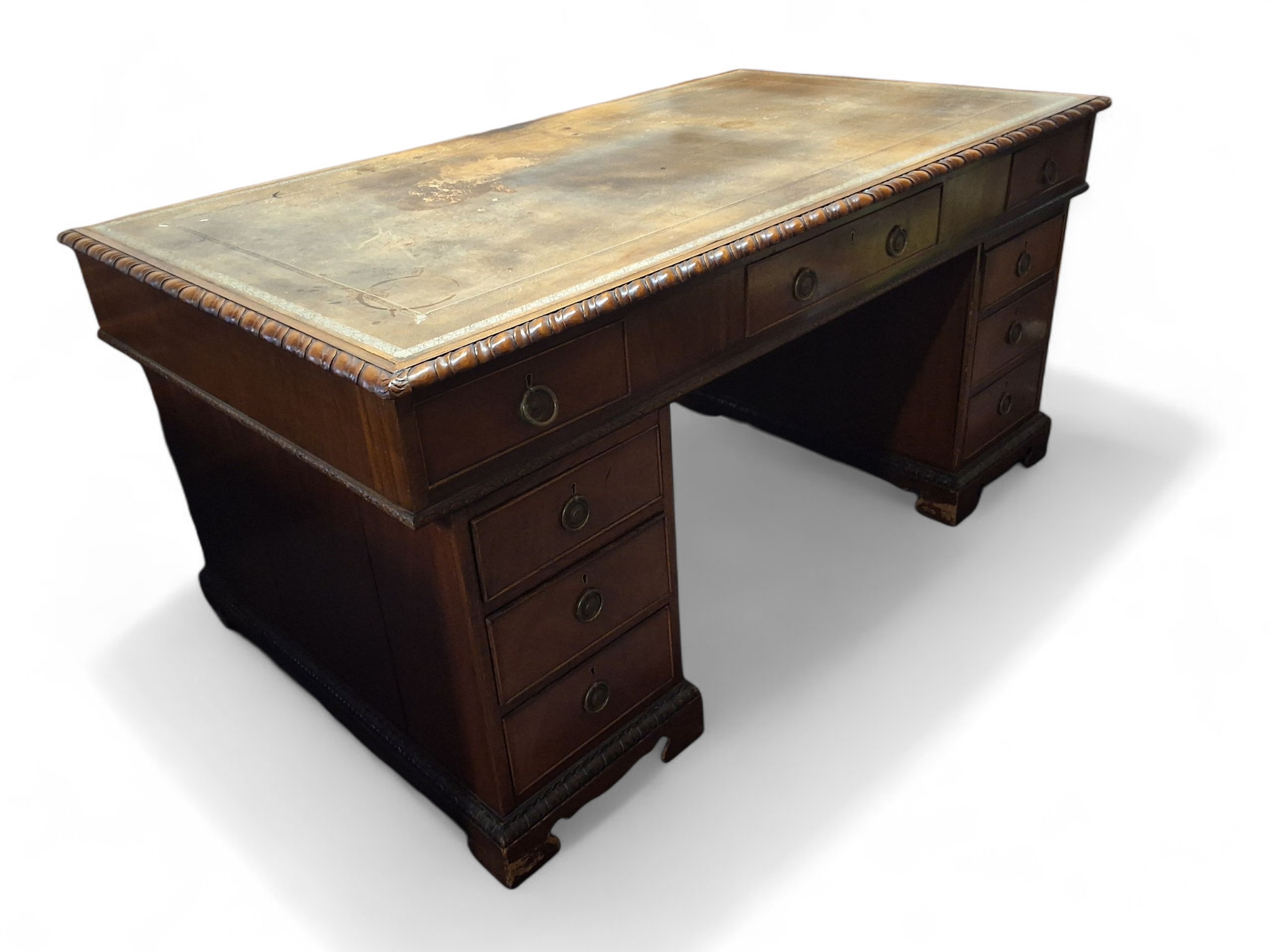 A 20th century mahogany partners' desk, rounded rectangular top with ...