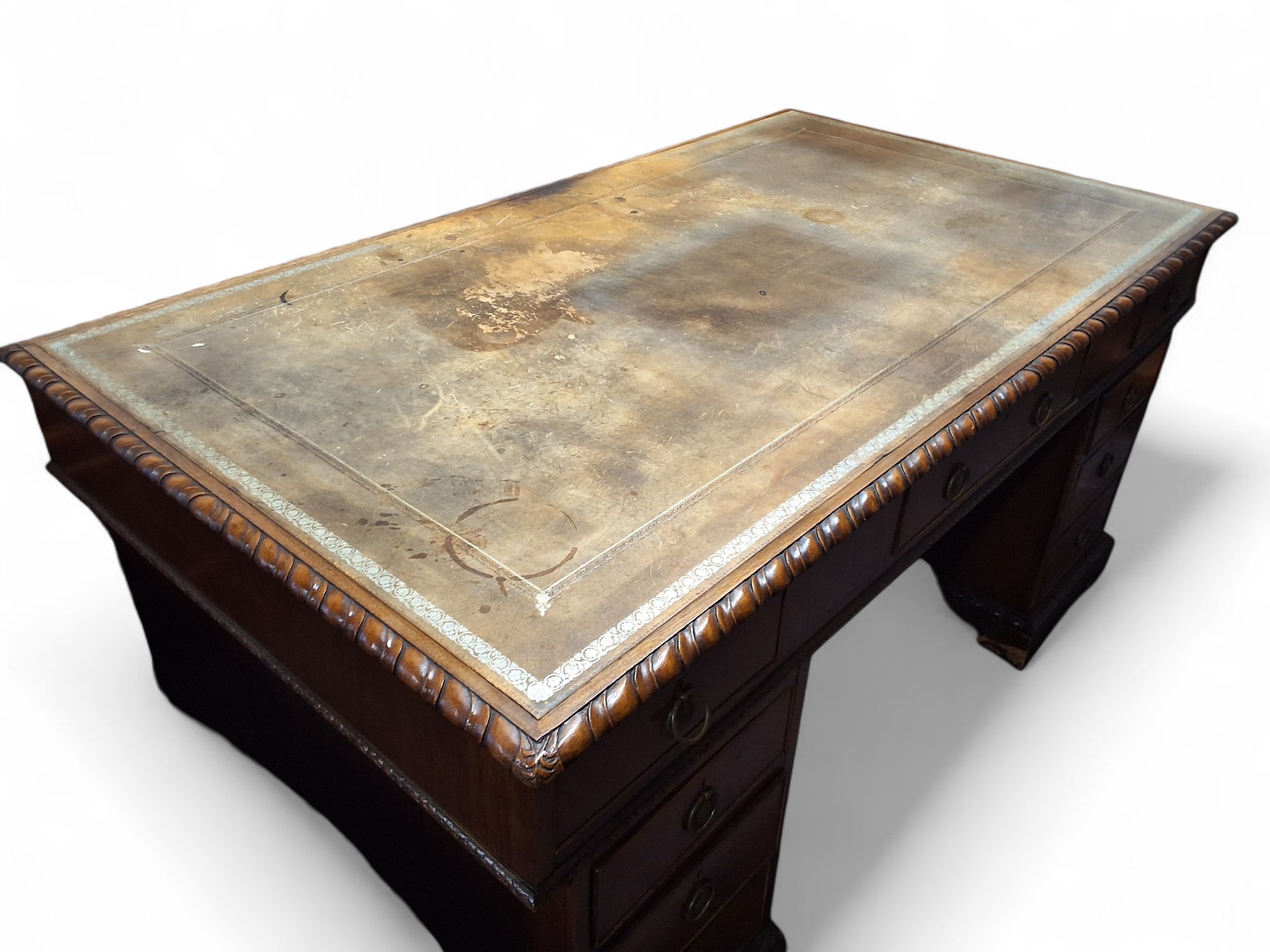 A 20th century mahogany partners' desk, rounded rectangular top with ...