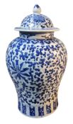 A 19th century Chinese inverted baluster vase, associated cover, painted stylised flowerhead and