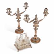 A PAIR OF 19TH CENTURY SILVER-PLATED CANDELABRA AND A SILVER-PLATED CUT-GLASS SIX-BOTTLE CRUET SET