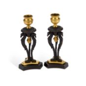 A PAIR OF REGENCY BRONZE AND ORMOLU CANDLESTICKS
