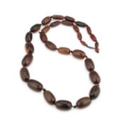 A STRING OF RHINOCEROS HORN GRADUATED BEADS LATE 19TH CENTURY