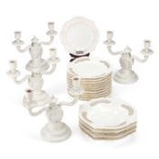 A SET OF FOUR NYMPHENBURG WHITE-GLAZED TWO-LIGHT CANDELABRA