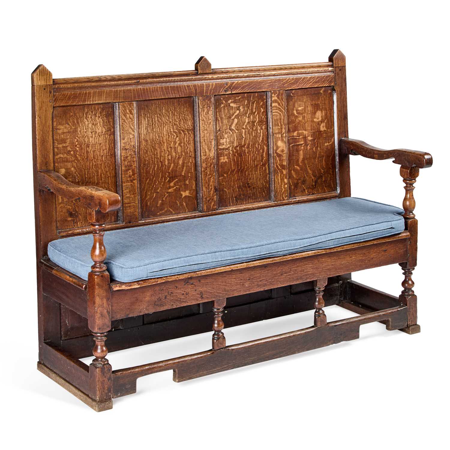 AN 18TH CENTURY OAK SETTLE with a four-panel back, raised on block and ...