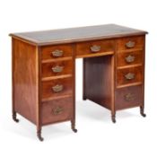 AN EDWARDIAN LEATHER-INSET MAHOGANY DESK