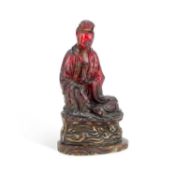 A CHINESE FAUX AMBER FIGURE OF BUDDHA