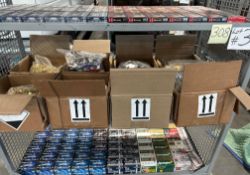 shelf of miscellaneous boxes of ammunition, shotgun shells, AR, 9, and others