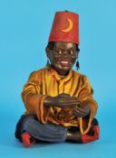 Automat mit Augenwender, Afrikaner im Schneidersitz