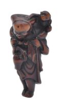 A WOOD NETSUKE OF A SARUMAWASHI (MONKEY-TRAINER) AND MONKEY, EDO PERIOD (1615-1868)