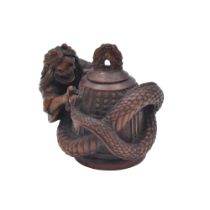 TANAKA MINKO OF TSU (1735-1816)A WOOD NETSUKE OF KIYOHIME ON THE BELL OF DOJOJI, EDO PERIOD