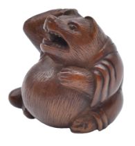 MASATSUGUA WOOD NETSUKE OF A TANUKI (RACCOON DOG) EDO PERIOD (1615-1868), EARLY/MID-19TH CENTURY