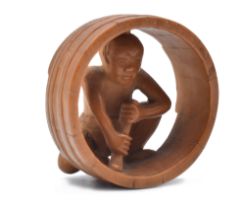 A WOOD NETSUKE OF A COOPER INSIDE A BARREL, EDO PERIOD (1615-1868) OR MEIJI ERA (1868-1912)