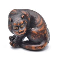 ATTRIBUTED TO NAITO TOYOMASA (1773-1856) OF TANBA A WOOD NETSUKE OF A TIGER, EDO PERIOD (1615-1868)