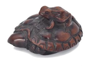 ΩA WOOD NETSUKE OF A FROG ON A TORTOISE, EDO PERIOD (1615-1868), 19TH CENTURY