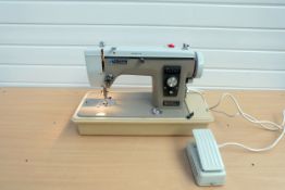 New Home 543210, 535 Sewing Machine With Plastic Cover.
