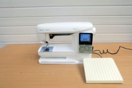 Husqvarna Viking Opal 690Q Sewing Machine With Plastic Cover.