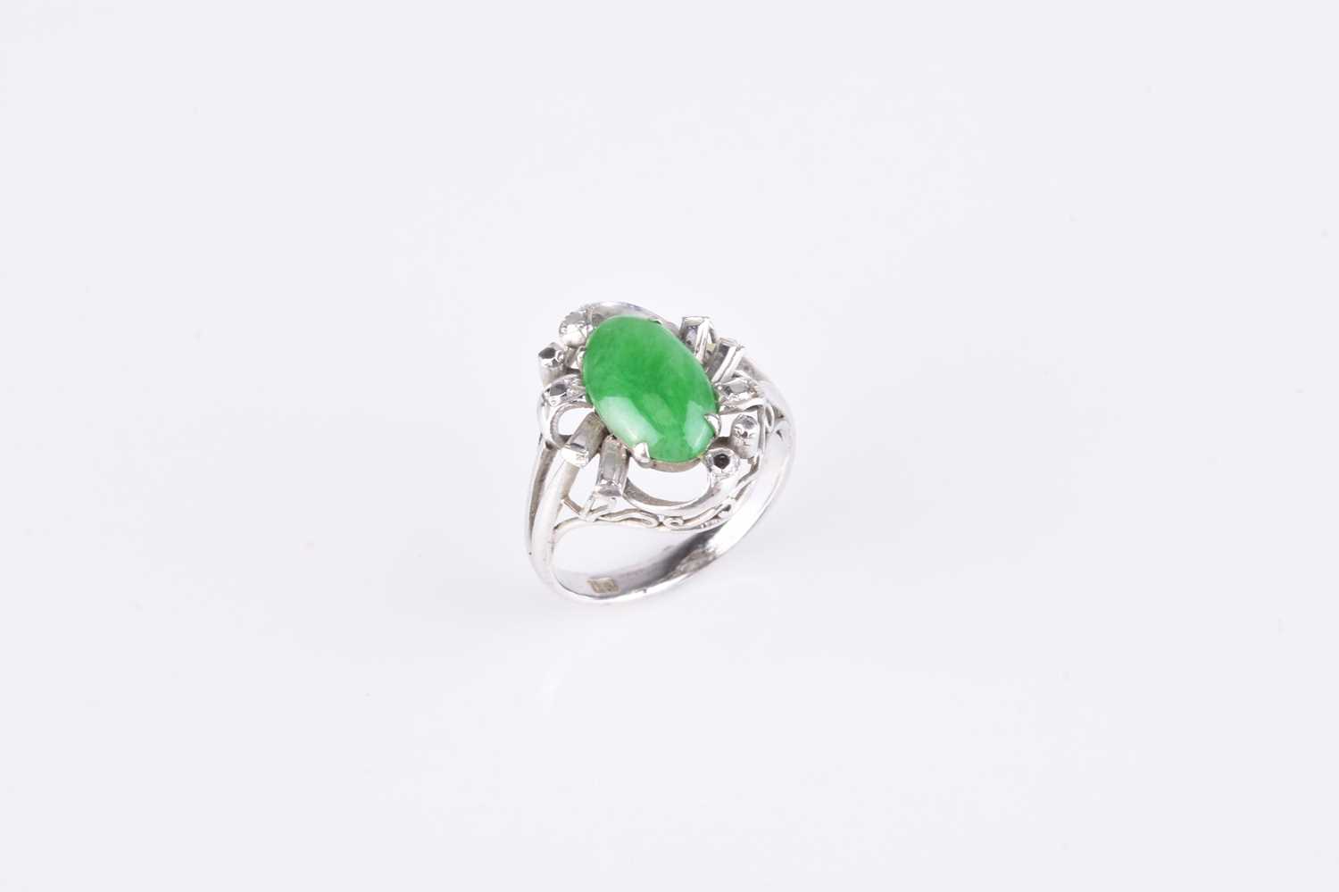 A white metal jade plaque ring