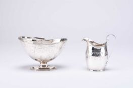 A George III silver helmet cream jug and a Victorian silver sugar basket